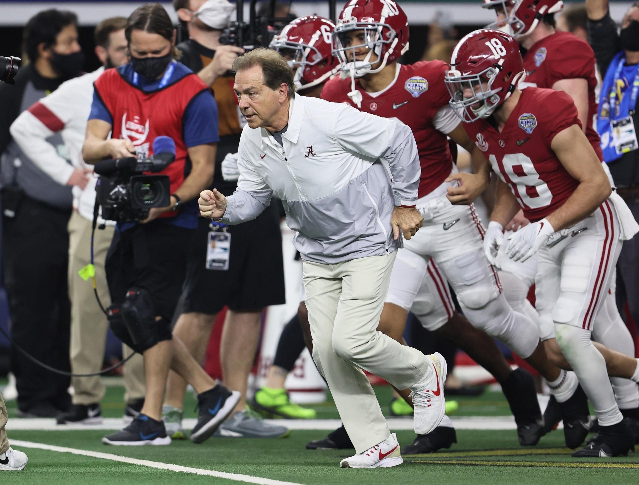 Alabama coach Nick Saban runs onto the field at the Cotton Bowl.