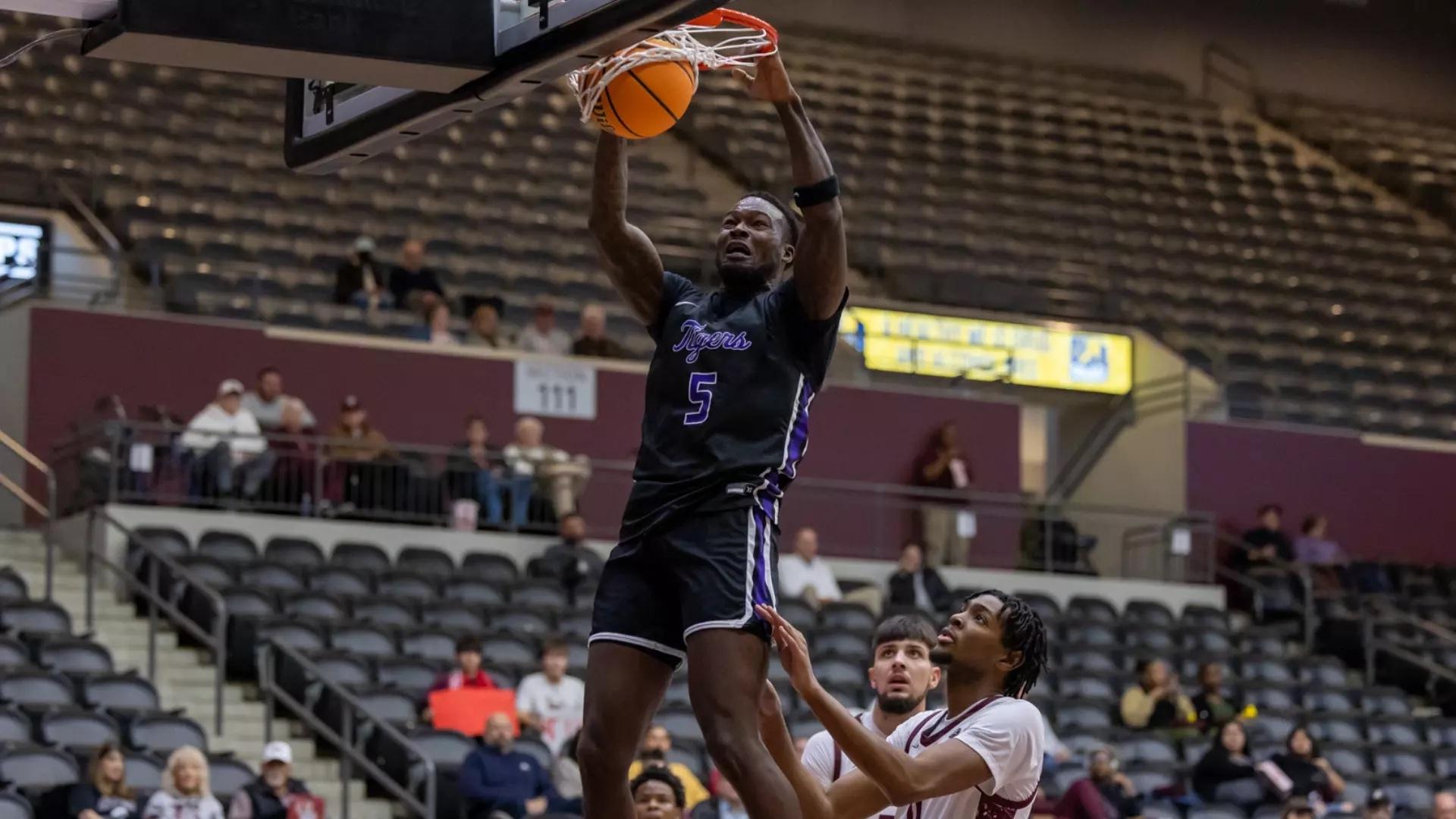 Ouachita Baptist's Hobert Grayson soars through the air in DII men's basketball. 